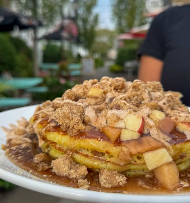 Apple Crumb Pancakes: apple compote, homemade crumbs and cinnamon cream glaze, out on the patio