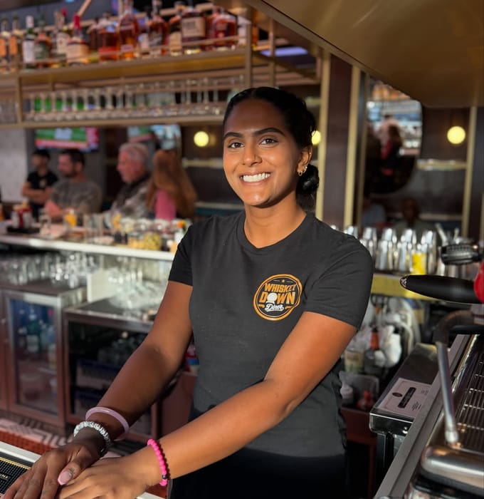 A bartender at the Babylon Village bar