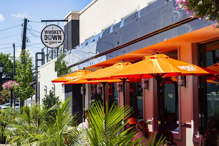 Orange umbrellas along the front of the restaurant