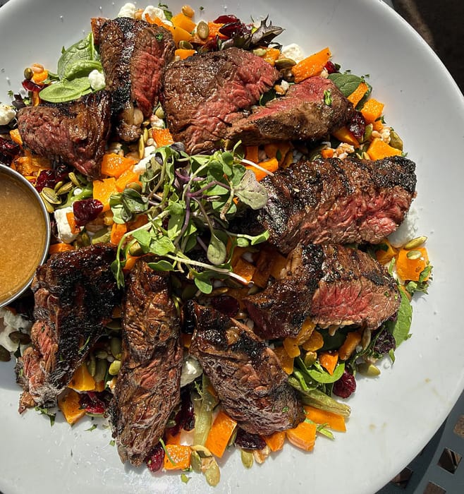 Harvest Moon Salad with skirt steak: roasted butternut squash, farro, craisins, pepitas and goat cheese
