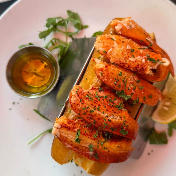 Maine lobster roll with drawn butter and lemon